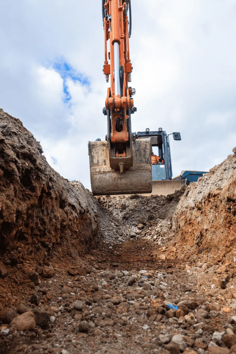 Excavator digging a trench on a groundworks site