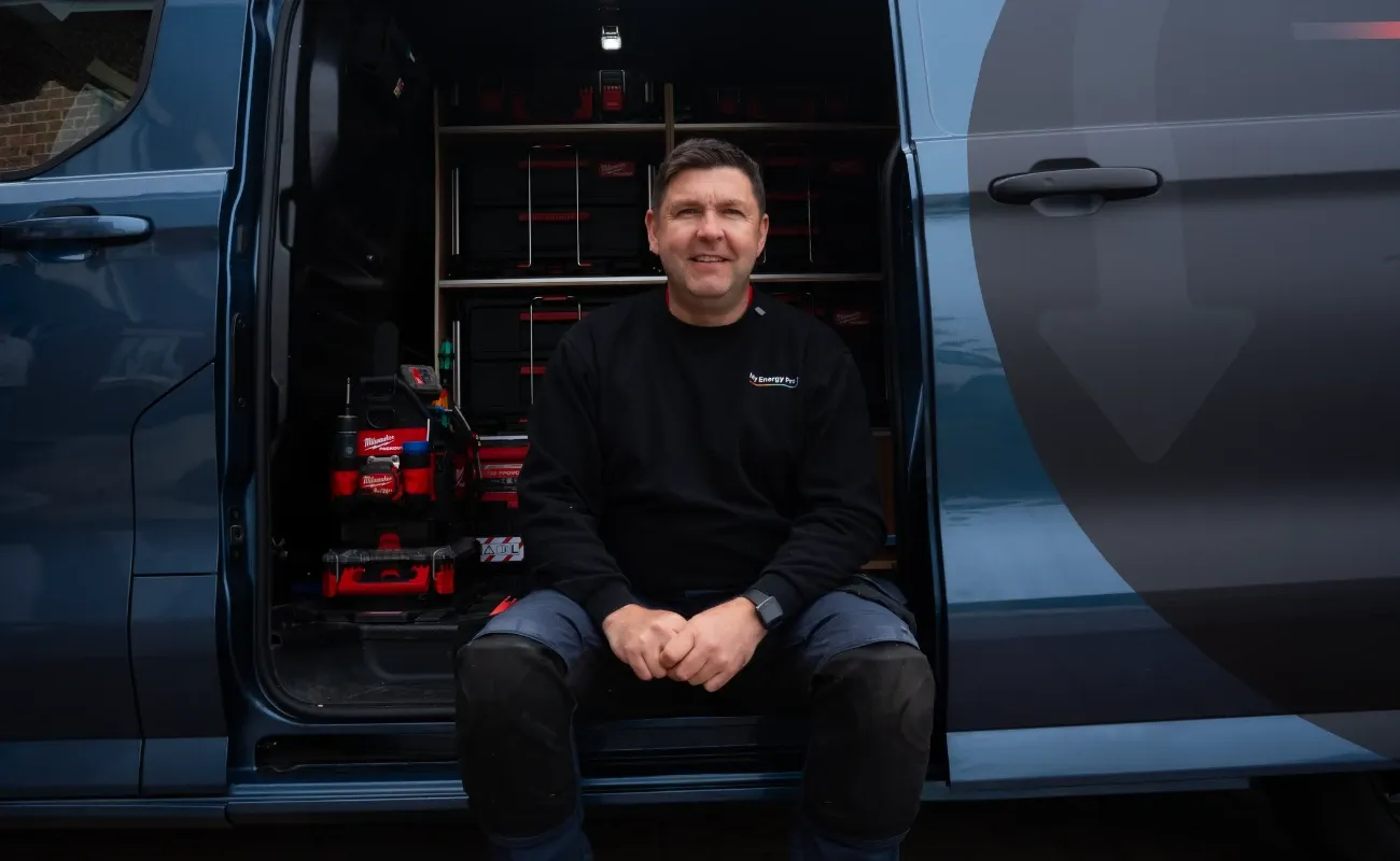 George Campbell of My Energy Pro sitting in the side door of his van