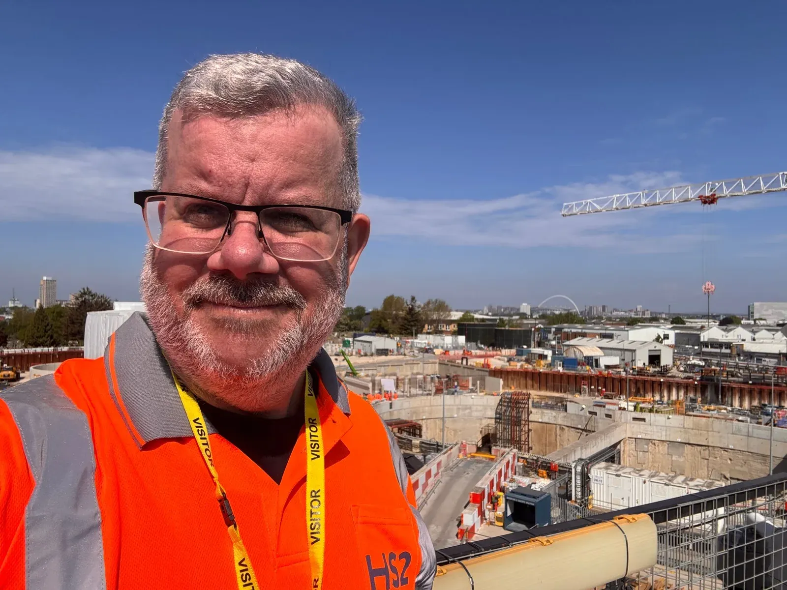 Steve Mark in a hi-vis vest on a site visit, overlooking an HS2 construction site